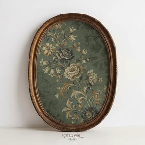 May include: An oval framed print featuring a floral design in shades of green, beige, and brown. The print has a gold-colored frame with a detailed edge. The text "LOTUS WALL PRINTS" is at the bottom.