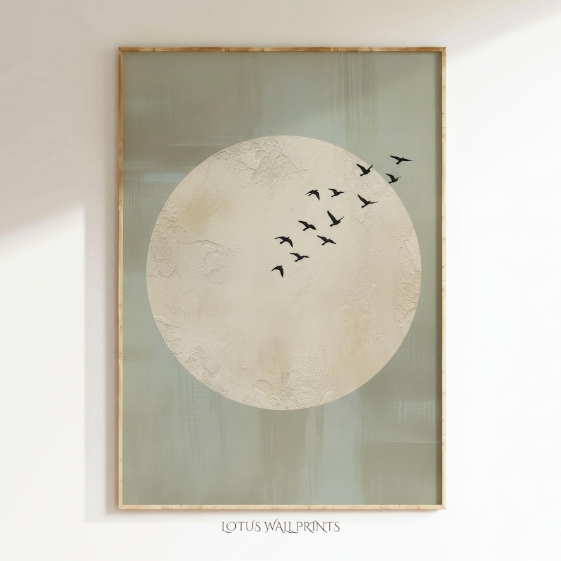 May include: A framed art print featuring a large, textured, off-white circle with a flock of black birds flying across it. The background is a muted green-gray. The text "LOTUS WALL PRINTS" is at the bottom.