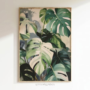 May include: A framed botanical print depicting large monstera leaves in various shades of green and white. The leaves have a distinctive split-leaf pattern. The print is set against a soft, neutral background, with the text "LOTUS WALL PRINTS" at the bottom.