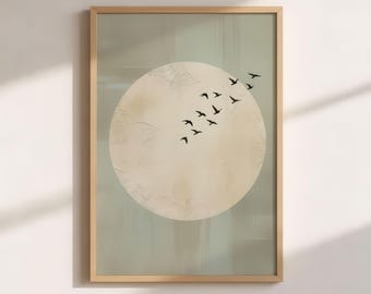 May include: A framed wall art print featuring a large, textured beige circle centered on a muted sage green background. A flock of small black birds is depicted in flight, moving diagonally across the upper right portion of the circular shape.