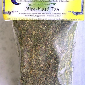 May include: A clear plastic bag filled with a blend of dried herbs, labeled "Cheshire's Herbals Mint-Maté Tea". The label is yellow with a green border and features a crescent moon logo. The text on the label reads "Caffeine-Free Organic and Wildcrafted Herbal Tea Blend Yerba Maté, Peppermint, Spearmint Love Traditionally used as: an antioxidant, a stimulant, and a coffee alternative."