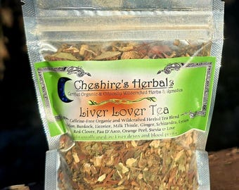 May include: A clear plastic bag filled with a blend of dried herbs for a Liver Lover Tea. The bag has a label with the text "Cheshire's Herbals Certified Organic & Ethically Wildcrafted Herbs & Remedies Liver Lover Tea Caffeine-Free Organic and Wildcrafted Herbal Tea Blend", and a list of ingredients including burdock, licorice, milk thistle, ginger, schizandra, lyrium, red clover, pau d'arco, orange peel, stevia, and love. The label also states that the tea is traditionally used for liver detox and blood purification.