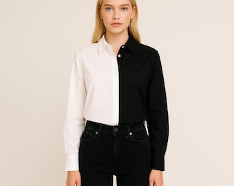 May include: A monochrome button-down shirt, split vertically with one half white and the other black. The shirt features a classic collar and long sleeves with buttoned cuffs. The model is wearing black jeans.