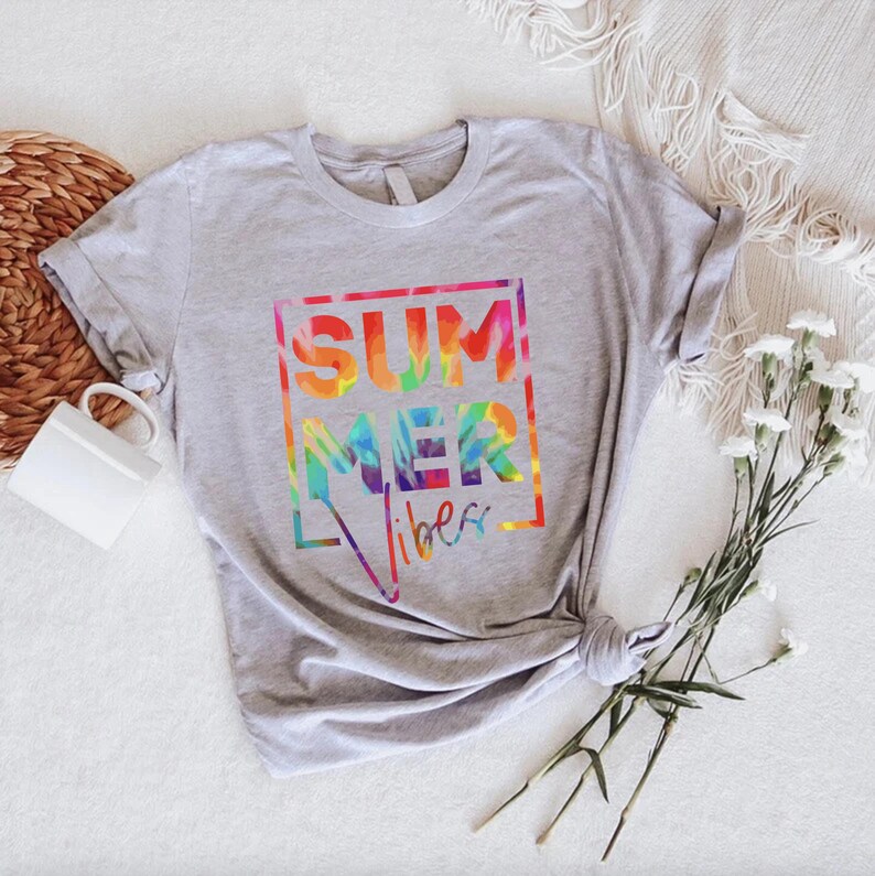 May include: A gray t-shirt with a tie-dye design that says "SUMMER vibes" in a white box.
