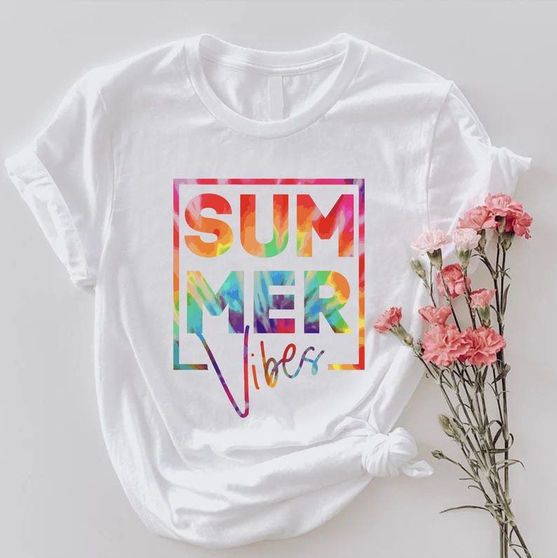 May include: White t-shirt with a rainbow tie-dye design that says "Summer Vibes" in a black box.