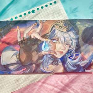 May include: A rectangular art print featuring a digital illustration of a character with pale blue hair and light eyes. The character wears a dark headpiece and gloves, holding a glowing blue teardrop-shaped gem between their fingers.