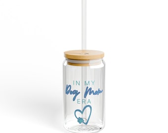 May include: A clear glass tumbler with a bamboo lid and a straw. The tumbler has a blue and white graphic that says "In My Dog Mom Era" with a paw print heart.