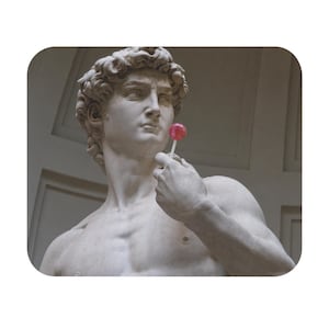 May include: A marble statue of David holding a red lollipop. The statue is a classical sculpture with detailed facial features and curly hair. The lollipop is round and appears to be a hard candy.