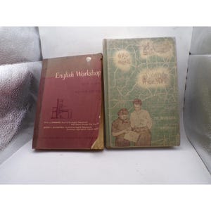 May include: Two vintage hardcover books. The left book is maroon with the title English Workshop New Series Review Course. The right book is light green with a map-like pattern, illustrations of people, and the title Guide to Modern English.