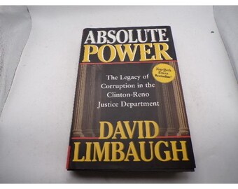 May include: A hardcover book titled "ABSOLUTE POWER" with a gold and black cover. The book's subtitle reads "The Legacy of Corruption in the Clinton-Reno Justice Department" by David Limbaugh. A "New York Times Bestseller!" sticker is visible.