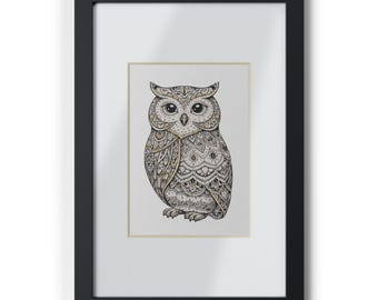 May include: Framed art print of an owl illustration. The owl is rendered in black and white with detailed patterns and gold highlights. The artwork is presented in a black frame with a white mount.