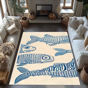 May include: A rectangular area rug with a cream-colored background and a blue fish pattern. The fish are stylized with detailed scales and fins, creating a nautical or coastal theme. The rug is placed in a living room setting.