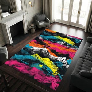May include: A rectangular area rug with a vibrant mountain landscape design. The rug features a black base with colorful brushstrokes in shades of pink, orange, yellow, blue, and white, creating a bold and modern aesthetic.