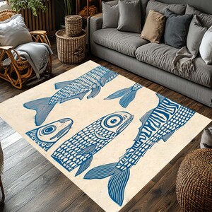 May include: A rectangular area rug with a cream-colored background features a repeating pattern of blue fish illustrations. The fish vary in size and orientation, creating a dynamic and artistic design. This rug is suitable for living rooms and bedrooms.