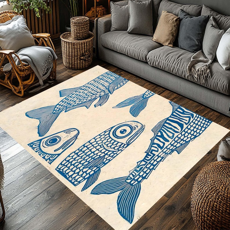 May include: A rectangular area rug with a cream-colored background features a repeating pattern of blue fish illustrations. The fish vary in size and orientation, creating a dynamic and artistic design. This rug is suitable for living rooms and bedrooms.