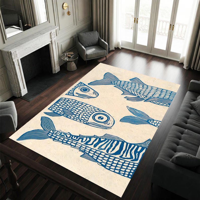 May include: A rectangular area rug with a cream background and a repeating pattern of blue fish illustrations. The fish vary in size and orientation, creating a whimsical design. The rug is placed on a dark wood floor.