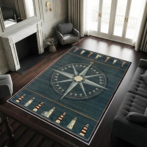 May include: A rectangular navy blue nautical-themed rug featuring a large compass rose design in shades of blue and cream. The rug has a border with lighthouse illustrations and rope detailing, suitable for a living room or nautical decor.