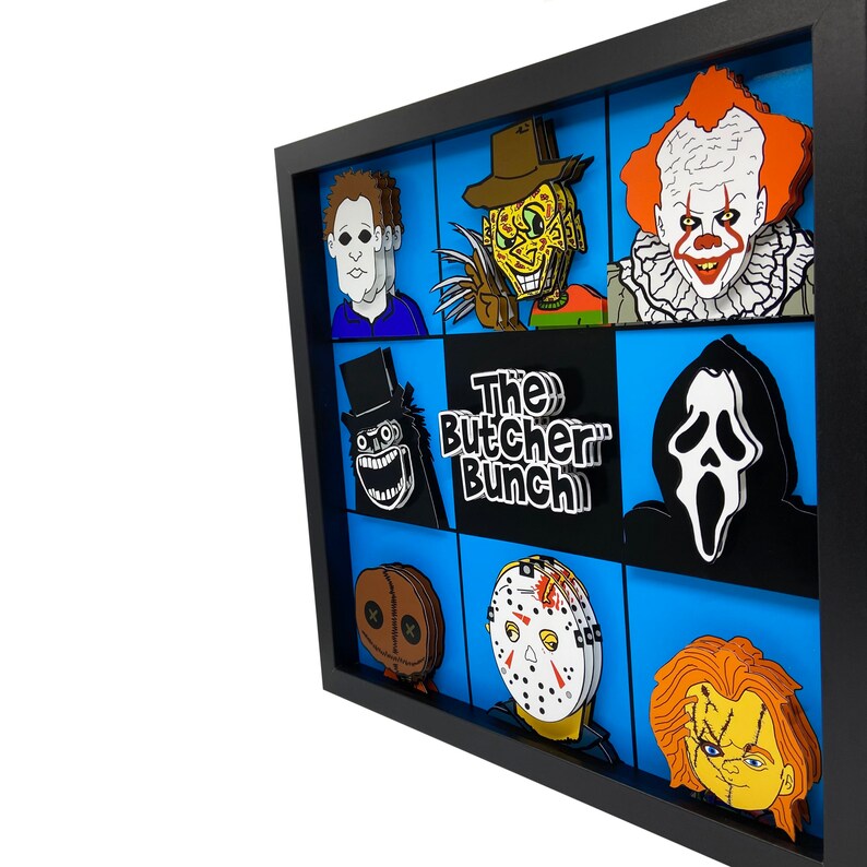 May include: A black framed picture with a blue background and a grid of 9 squares. Each square features a different horror movie character, including Freddy Krueger, Jason Voorhees, Michael Myers, and Ghostface. The title "The Butcher Bunch" is in the center of the grid.