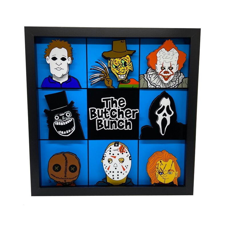 May include: A black framed shadow box with a blue background and nine different horror movie character pins. The pins include Jason Voorhees, Freddy Krueger, Michael Myers, Leatherface, Chucky, Ghostface, Pennywise, and the Creeper. The title "The Butcher Bunch" is printed in white letters on a black background.