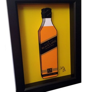 May include: A framed illustration of a bottle of Johnnie Walker Black Label 12 year old blended Scotch whisky. The bottle is depicted in a 3D style, with a yellow background and a black frame. The image is signed "Josh 2015".