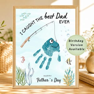 May include: A framed print featuring a teal handprint shaped like a fish on a light blue background. The text reads I CAUGHT THE best Dad EVER and HAPPY Father's Day. A fishing rod, small fish, seahorse, and seaweed are illustrated.