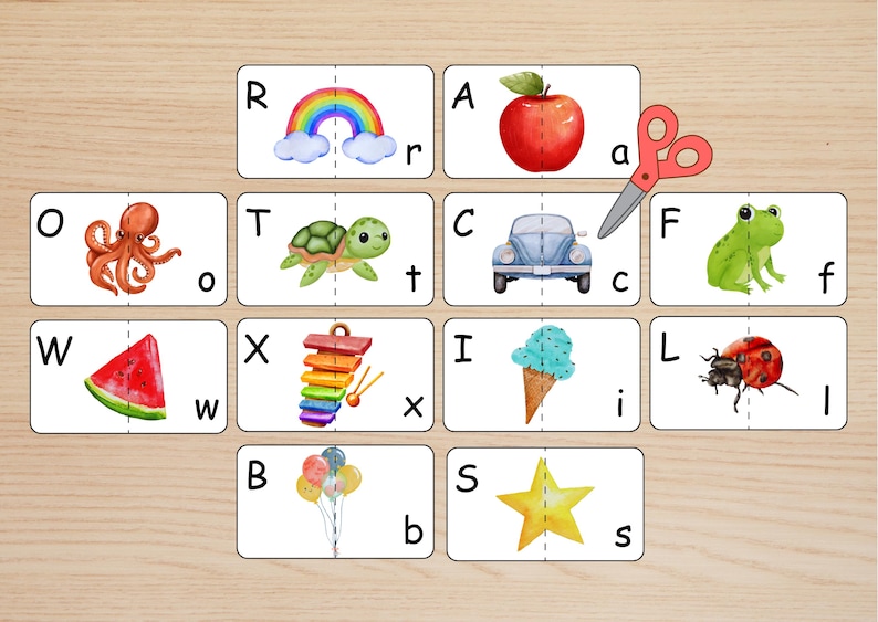 May include: A set of rectangular educational cards featuring uppercase and lowercase letters paired with watercolor illustrations including a rainbow, apple, octopus, turtle, car, frog, watermelon, xylophone, ice cream, ladybug, balloons, and star.