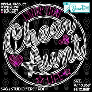 May include: A black digital graphic with the words "Living That Cheer Aunt Life" in a circle, made of white rhinestones. Pink hearts and stars accent the design. The dimensions are 10.868 inches wide and 10.868 inches high.