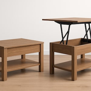 May include: Two wooden coffee tables in a light brown finish. One is a standard design, the other has a lift-top mechanism. Both tables have a lower shelf. The lift-top table has black metal supports and a raised top.