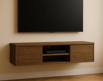 May include: A wall-mounted, dark brown wooden media console with two cabinet doors and an open shelf. A black flat-screen television is mounted above the console. The console has a modern design and is suitable for a living room or entertainment area.