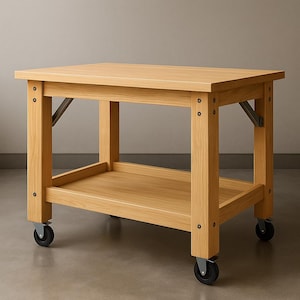 May include: A light oak kitchen island with a rectangular top and a lower shelf. It features four legs with black wheels. Metal brackets provide support. The design is simple and functional. The island's dimensions are approximately 100cm x 60cm.