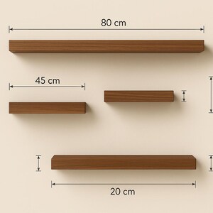 May include: A set of four floating wooden shelves in varying lengths. The longest shelf is 31.5 inches long, and the shortest is 7.9 inches. All shelves are 7.9 inches deep. The shelves are a warm brown color and are mounted on a neutral-colored wall.