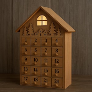 May include: Wooden advent calendar shaped like a house. It has 24 numbered drawers with small wooden knobs. The roof has a glowing window and a decorative silhouette of trees and houses. The calendar is made of light-colored wood.