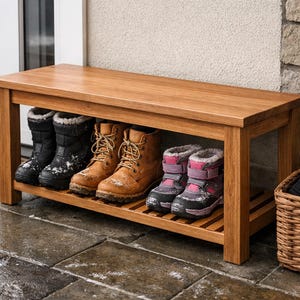 May include: A wooden shoe bench with a slatted shelf holds several pairs of winter boots in various colors. A woven basket with hats and gloves sits nearby. The bench is made of light brown wood.