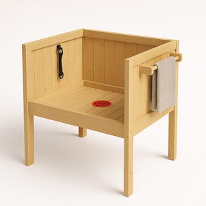 May include: A light-colored wooden pet washing station with a red drain cover and a black leash. A small towel hangs on a wooden bar. The station has a square shape and is elevated on four legs.