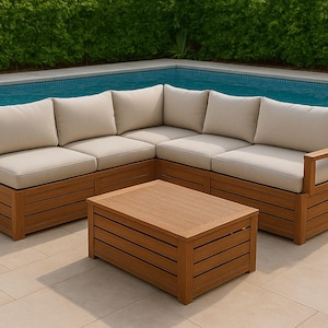 May include: A wooden sectional sofa with beige cushions and a matching coffee table. The outdoor furniture set is made of light brown wood and is positioned near a swimming pool. The sofa has a modern design.
