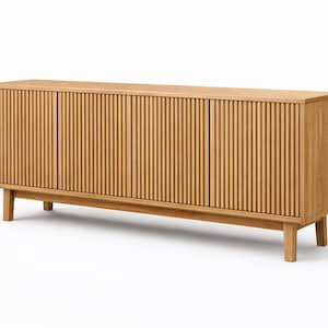 May include: A light brown wooden cabinet with three doors and a slatted design. The cabinet sits on four short legs and has a rectangular shape. The doors have vertical grooves.