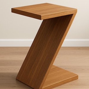 May include: A modern, Z-shaped side table made of wood. The table has a square top and a base, connected by a diagonal support. The wood has a warm, medium brown tone and visible grain. The table is designed for indoor use.