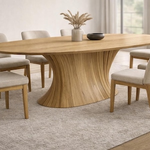 May include: A light wood oval dining table with a unique, curved base, surrounded by six upholstered chairs. The chairs have light-colored fabric seats and backs. A vase with dried plants and a dark bowl are on the table. The room has a neutral color palette.