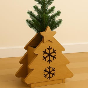 Peut inclure: Décoration en bois en forme de sapin de Noël avec un sapin vert à l'intérieur. L'arbre en bois a une étoile sur le dessus et des découpes de flocons de neige. La décoration est en bois brun clair.