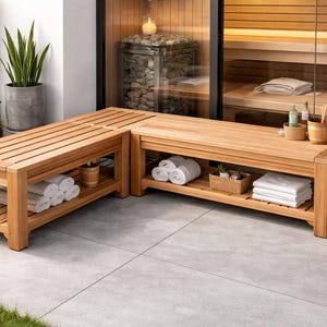 May include: Wooden sauna benches arranged in an L-shape, with slatted tops and lower shelves. The benches hold rolled white towels, a small basket, and wooden buckets. The scene is set outdoors with a sauna visible in the background.