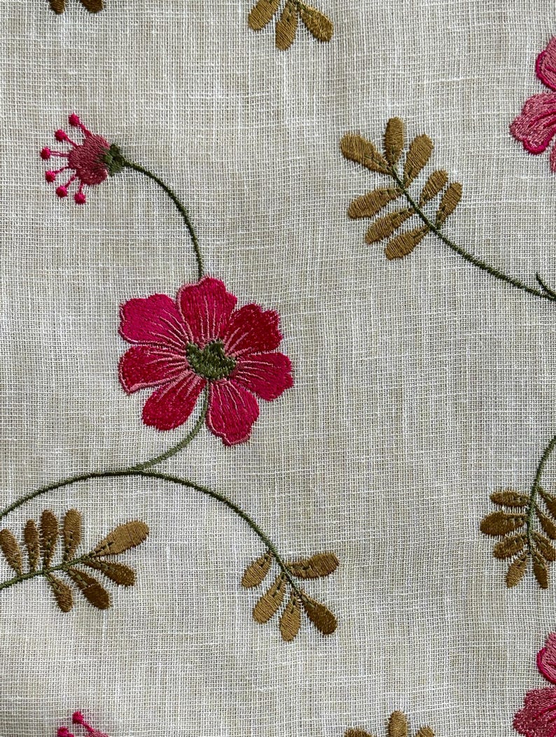 May include: A white fabric with embroidered pink flowers and brown leaves. The fabric has a subtle linen texture.