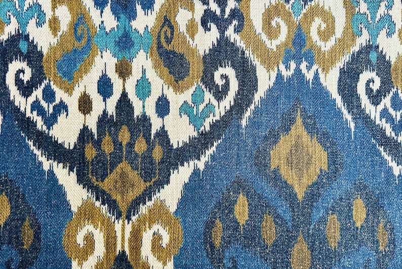 May include: Blue, brown, and white patterned fabric with an ikat design.