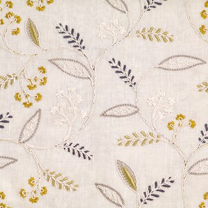 May include: White fabric with an embroidered floral pattern in shades of gray, yellow, and white. The design features delicate leaves and small flower clusters.