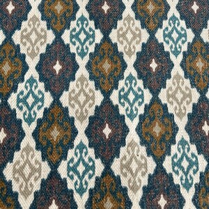 May include: A fabric with a repeating pattern of diamond shapes in shades of brown, blue, and white. The pattern is intricate and features a small floral design within each diamond.