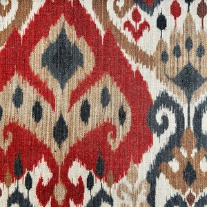 May include: Red, brown, black and white patterned fabric with an ikat design.