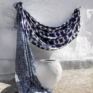 May include: A white ceramic pot with a blue and white patterned fabric draped over it. The fabric has a tie-dye pattern and a geometric pattern.