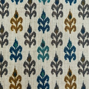 May include: A white fabric with a repeating pattern of blue, teal, brown, and gold stylized floral designs.