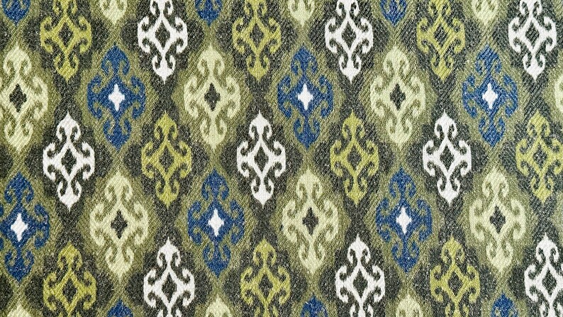 May include: A fabric with a repeating pattern of diamond shapes in shades of green, blue, and white. The pattern is intricate and features a stylized floral design.