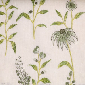 May include: White fabric with an embroidered floral pattern in shades of green. The design features delicate flowers and leaves.