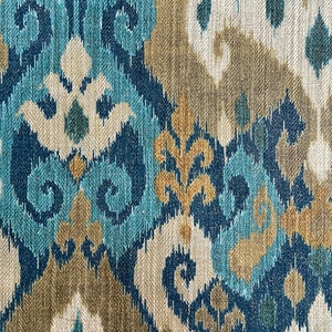 May include: Blue, beige, and gold patterned fabric with an ikat design.